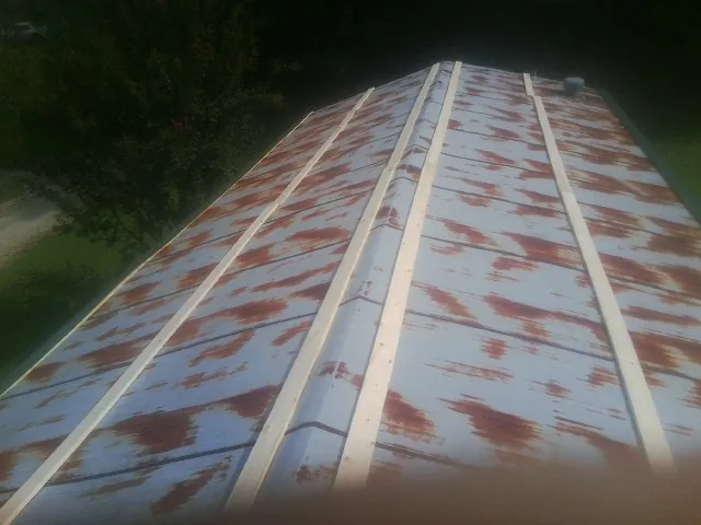 Rusted metal roof panels with new wood purlins before replacement — Storm Damage Roof Repair in New Egypt by Roofing Brothers