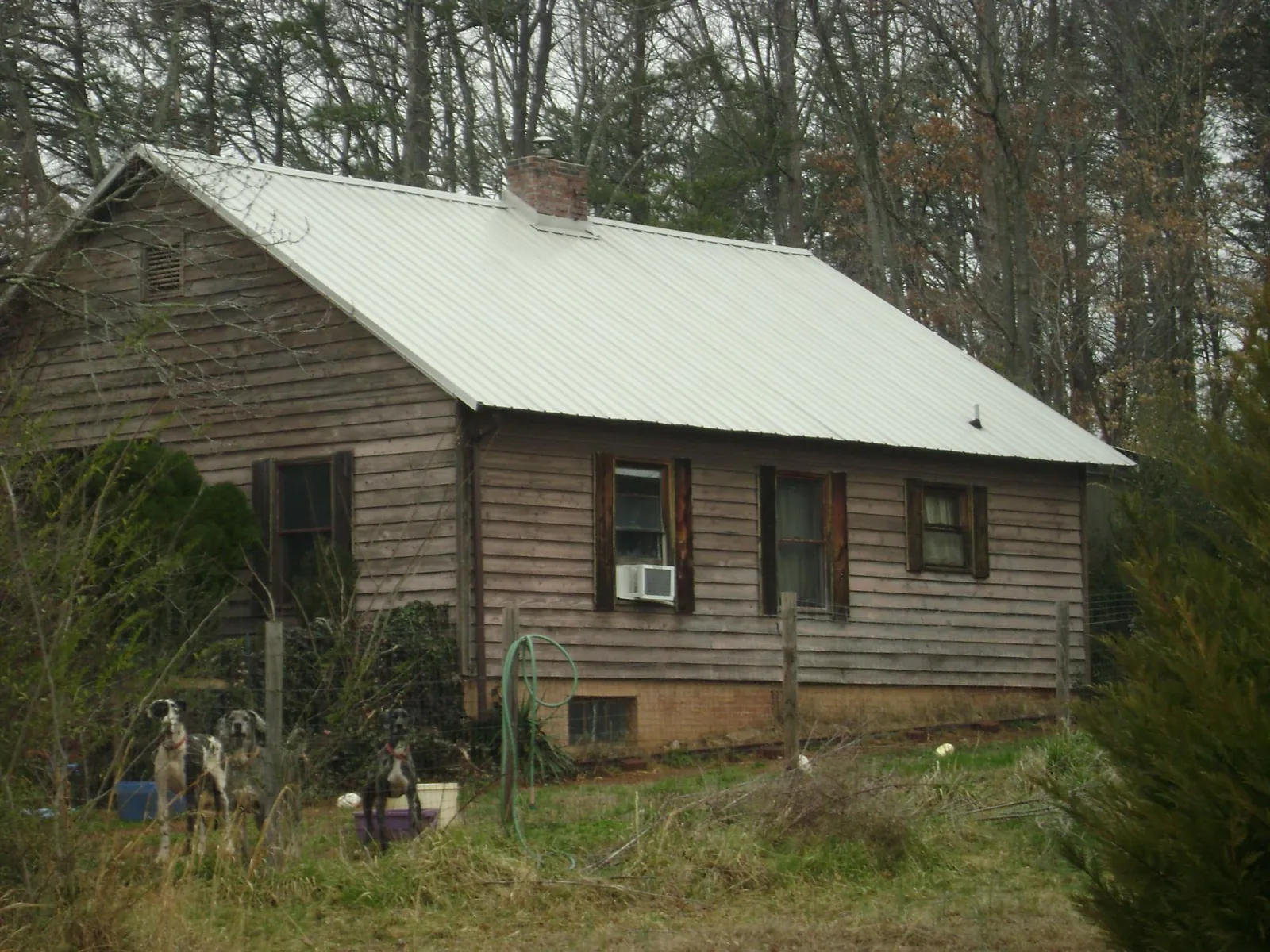 White metal roof on an old wood sided farmhouse, from a Asphalt Shingle Roof Repair job in New Egypt